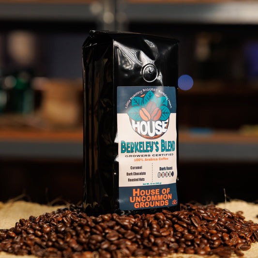 Bag of Berkeley's Blend coffee from House of Uncommon Grounds on a bed of roasted beans