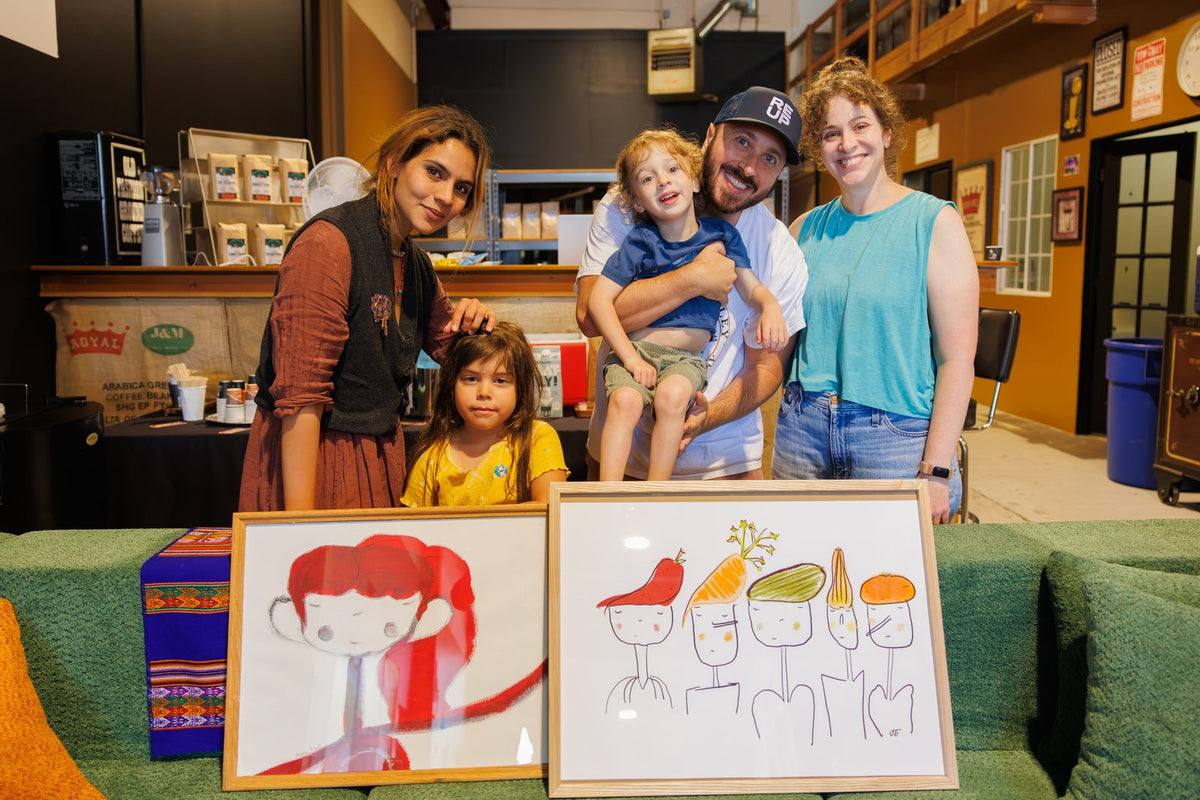A family showing their artwork at a House event
