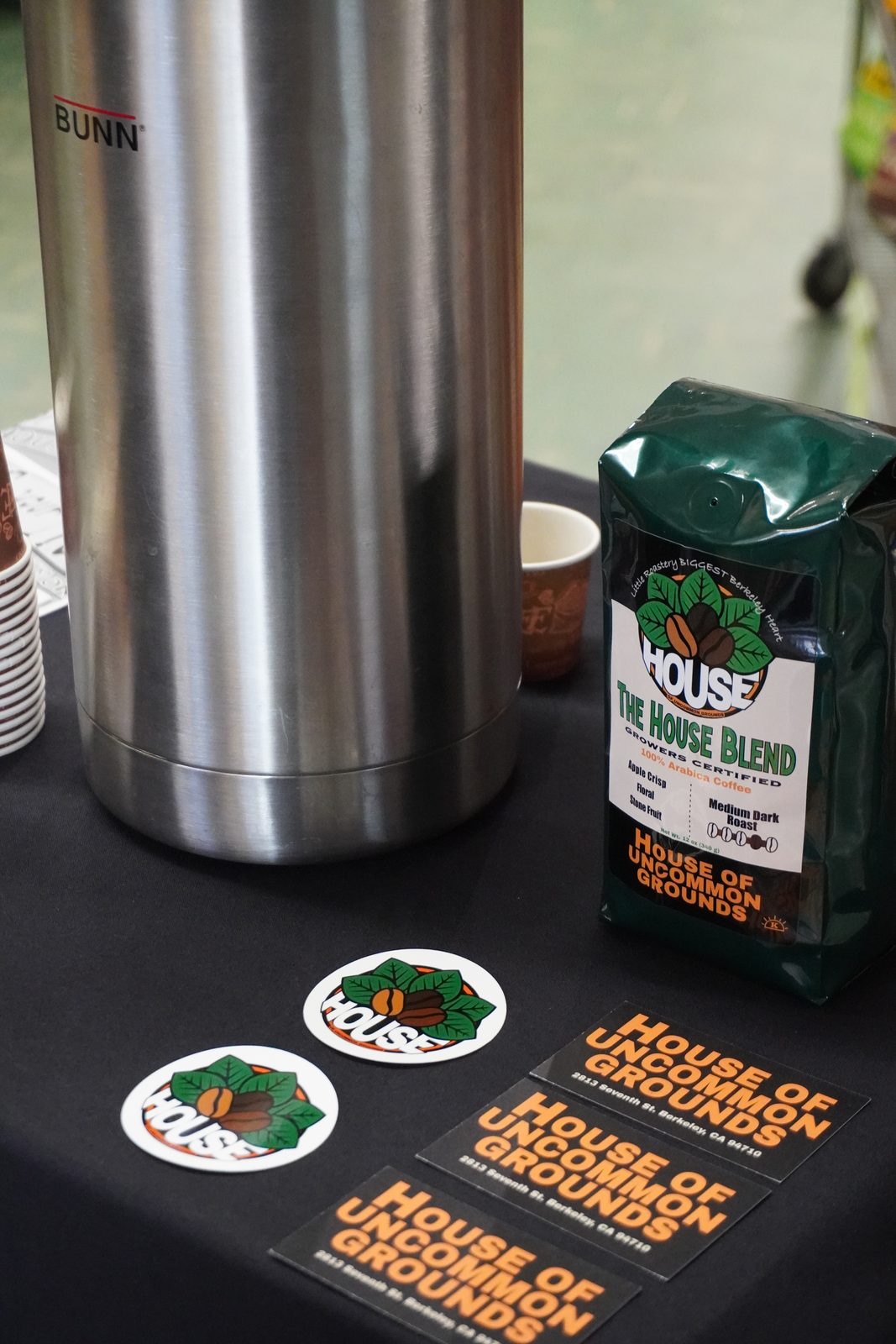 A bag of The House Blend beside a coffee dispenser