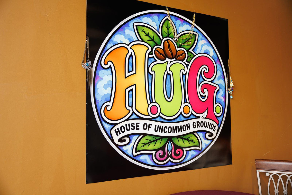 The H.U.G. House of Uncommon Grounds sign at the roastery